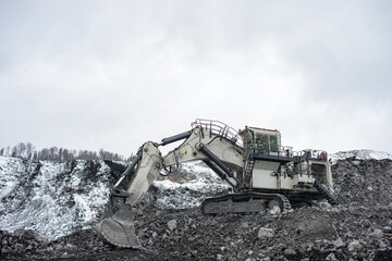 Big excavator in a coal mine on a sunny day