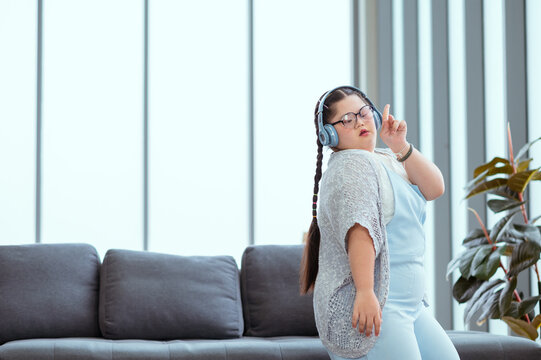 Autistic girl exercises and sings happily at home.