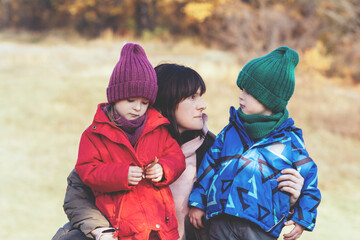 Happy mother, daughter and son in nature. Family, parenting and healthy relationship concept