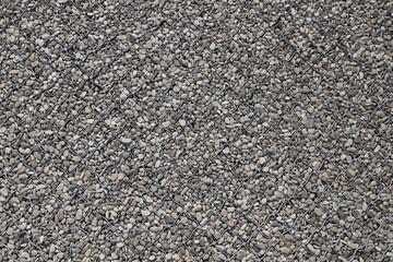 Pedestrian walkway made of small pebbles and metal mesh close-up