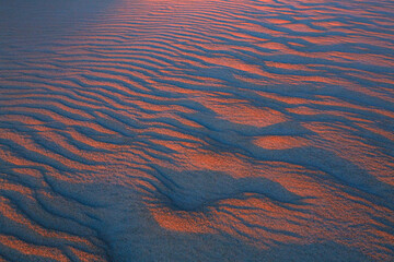 Wavy and narrow patterns in the sand before dawn