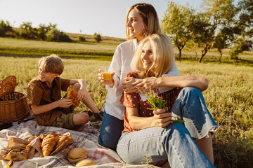 White family making fun during picnic on summer field