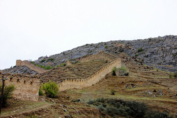 Fototapeta na wymiar Gunibsky fortress. Protective wall and gates of Gunib. Russia, Republic of Dagestan.