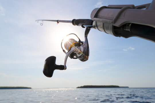 Fishing reel closeup view with sun rays.