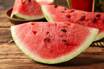 Delicious fresh watermelon slices on wooden table, closeup