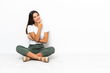 Teenager girl sitting on the floor smiling
