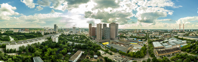 Fototapeta na wymiar panorama from a drone on a residential area of Moscow. new high-rise buildings against the background of old low houses. general plan