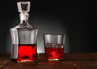 decanter with alcohol and glass with ice