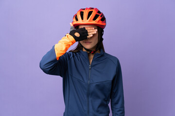 Teenager cyclist girl covering eyes by hands. Do not want to see something