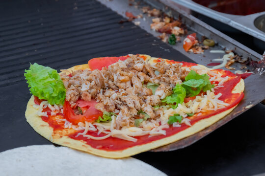 Preparing Fresh Quesadilla On Black Grill At Summer Local Food Market - Close Up View. Outdoor Cooking, Barbecue, Gastronomy, Cookery, Street Food And Traditional Mexican Dish Concept