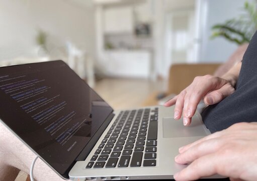 A person typing using a Laptop during the coronavirus pandemic, working from home