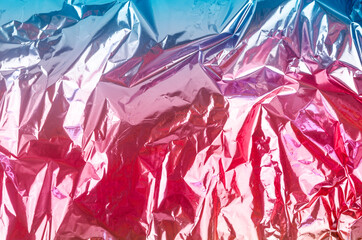 Colourful foil background with shiny crumpled surface.