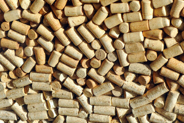 Background texture of a lot of used wine corks. The quality wine industry uses cork stoppers from...