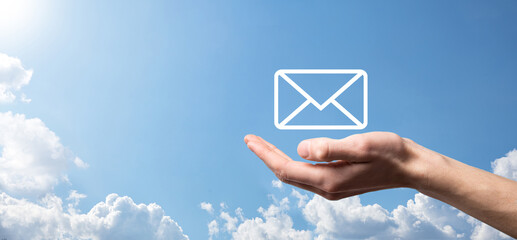 Businessman hand holding e-mail icon, Contact us by newsletter email and protect your personal...