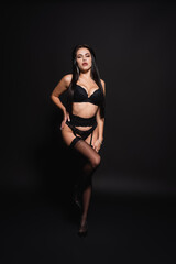 Obraz premium full length view of sexy woman in underwear and heels standing on black