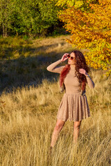 a beautiful elegant woman posing on a sunny autumn day.