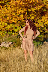 a beautiful elegant woman posing on a sunny autumn day.
