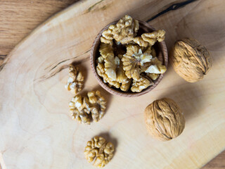 Bowl with delicious walnuts on a wooden table
