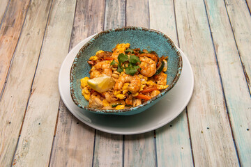 Pad thai, rice noodles, fish sauce, tamarind paste, red pepper, bean sprouts, shrimp, chicken with chopped peanuts and coriander, lemon wedge, banana flower, palm sugar and toasted chili pepper