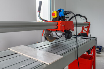 Cutter machine for ceramic tiles. A flat during renovation.