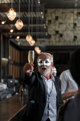 Fototapeta premium Champagne glasses holding on hand's Elder man in funny and happy Christmas and new year party atmosphere. Holiday celebrate and nightlife lifestyle concept