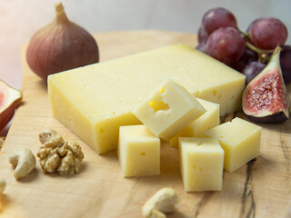 cheese with holes, grapes, nuts, Snack table with appetizers