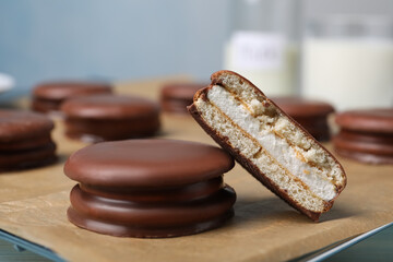 Tasty choco pies on parchment paper, closeup view