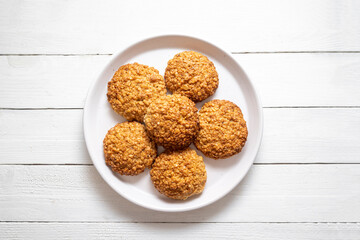 Homemade oat cookies in a plate, healthy dessert, bright background