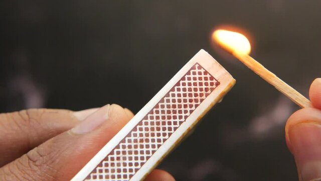 close up of lighting a match