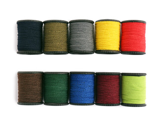 Set of colorful sewing threads on white background, top view