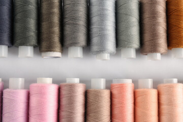 Set of colorful sewing threads on white background, flat lay