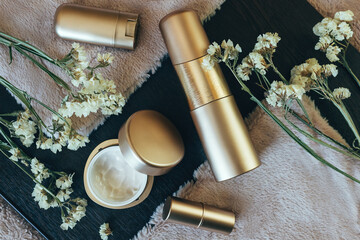A set of cosmetics for skin care. Premium product. There is room for text. Gold color of cans and tubes. Cosmetics for the whole family. Suitable for online advertising