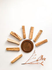 beautiful layout of palo santo and white sage, aromatherapy and incense on a white background. Place for text, religious minimalistic background