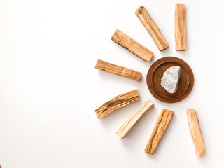 A set of wooden sticks Palo Santo on a white background. Aromatherapy and religious rites and meditations. Organic holy tree incense from Latin America top view