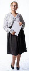 girl studio. model posing at the camera with a book. isolated white background. girl in trousers and blouse, shoes