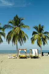 Fototapeta na wymiar Kiosks on the shore of the beach overlooking the sea. Santa Marta, Magdalena, Colombia. 