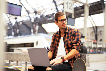 Man shopping online with laptop. Young man buying online with credit card.