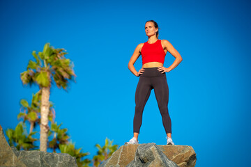 Full Length Body Beautiful Blonde Caucasian Woman Red Shirt Yoga Pants Strong Muscular Fit Looking of into distance Healthy Lifestyle Runner Determination and Focus After Before Workout Weight Loss