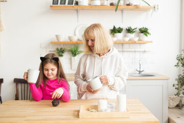 Grandmother and granddaughter having fun together at home. Generation and family concept