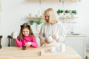Grandmother and granddaughter having fun together at home. Generation and family concept