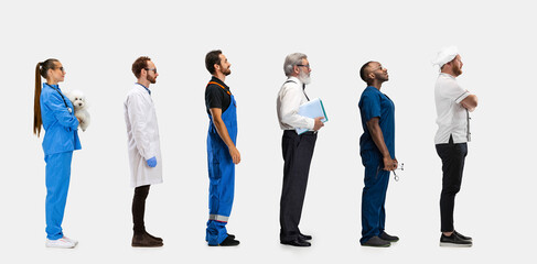 Group of gender mixed people with different professions, jobs standing isolated on white studio background. Horizontal flyer, collage. Side view