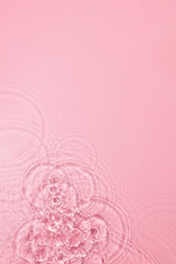 Transparent pink colored clear water surface texture with ripples, splashes and bubbles. Abstract nature pink background Water waves in sunlight with blank space for cosmetic advertising