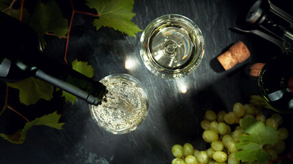 Top shot of pouring white wine into glass.