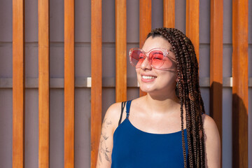 Cheerful Hispanic woman near wooden planks