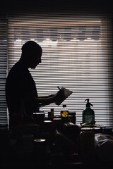 Man taking inventory of his food at twilight due to imminent crisis