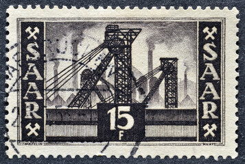 Cancelled postage stamp printed by Germany, Saarland, that shows Colliery shaft head, circa 1955.