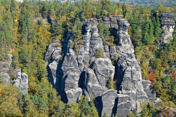High cliffs under the rays of the sun and coniferous forest