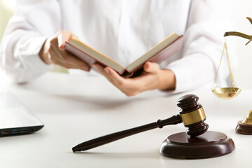 Lawyer working with contract papers and wooden gavel on tabel in courtroom. justice and law...