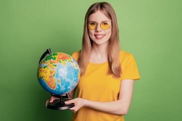 Portrait of cute adorable tourist lady hold globe demonstrate trip option wear sunglass yellow t-shirt