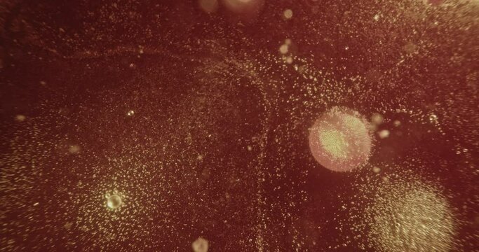 Red oil bobbles fizzing and exploding 